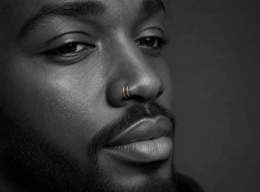 man with gold hoops in double nostril piercing