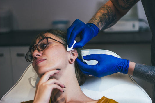 girl getting ear pierced