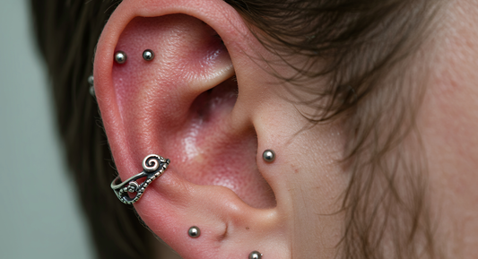 side view of tragus, conch and multiple ear piercings